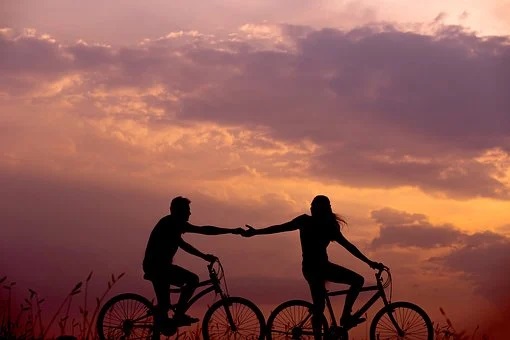 image of two people on a bicycles